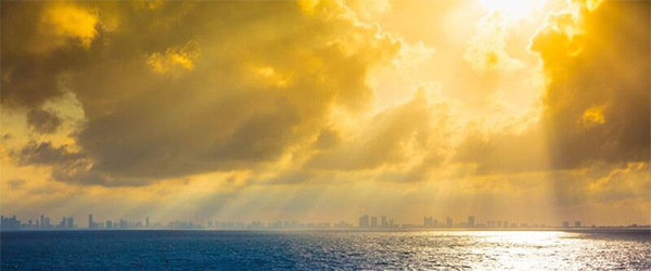 sunlight beaming through the clouds in Miami, Florida.